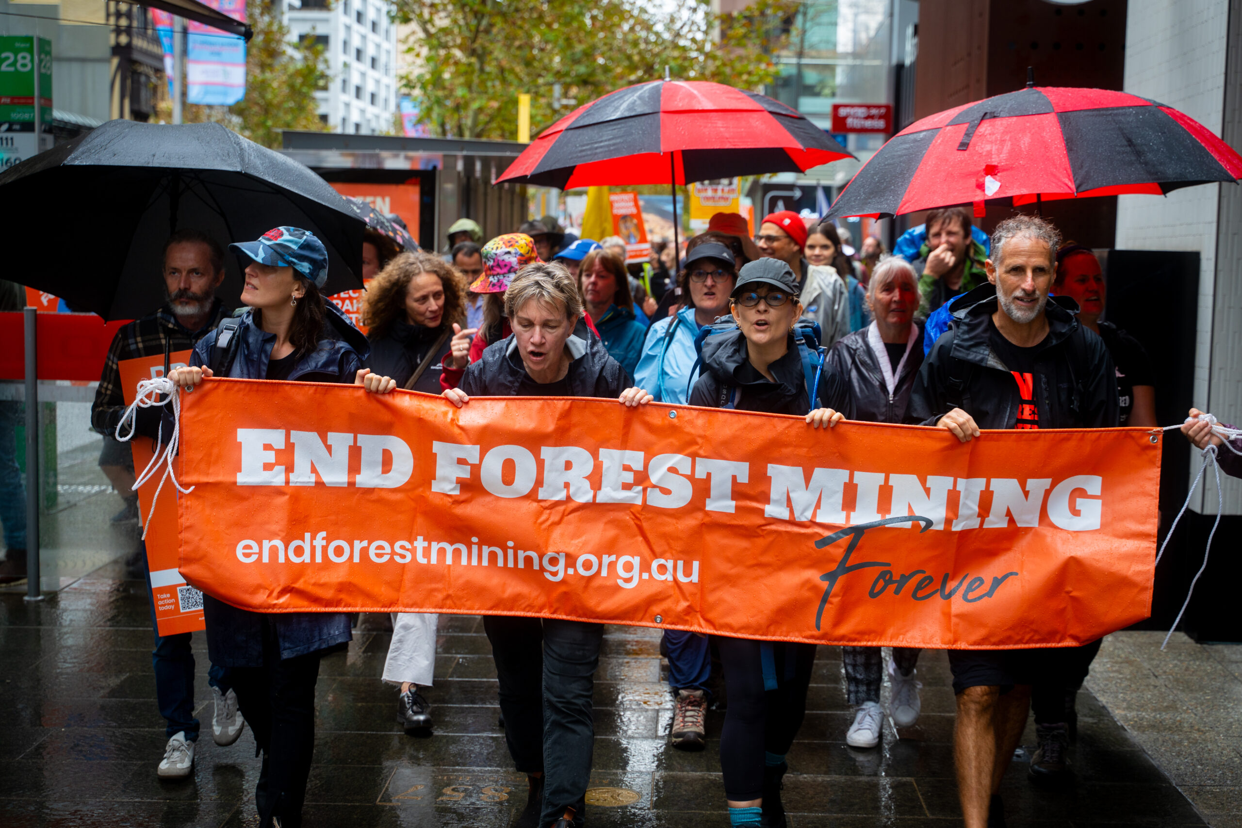 Big Jarrah Rally walkers with a sign reading "End Forest Mining"
