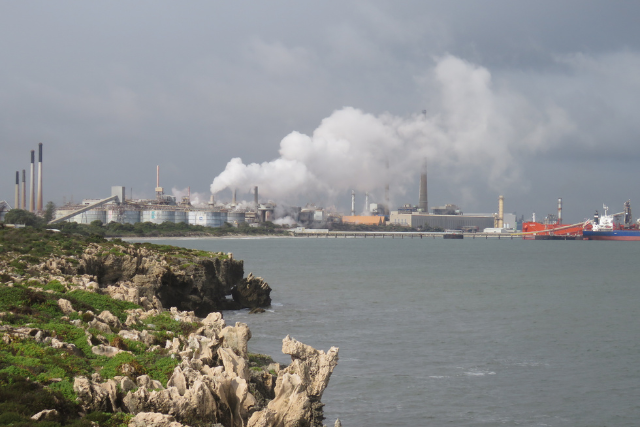 Alcoa's Kwinana Refinery seen from Henderson Cliffs. Smoke or steam is seen billowing from the building.